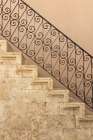 Stone staircase with ornate wrought iron balustrade. Greece, Crete, Chania. Art Print